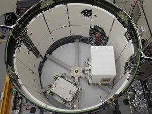 The Earth Surface Mineral Dust Source Investigation (EMIT) mission instrument (right) sits in the "trunk" that will travel aboard SpaceX's 25th cargo resupply mission – planned for June 7, 2022 – to the International Space Station. 