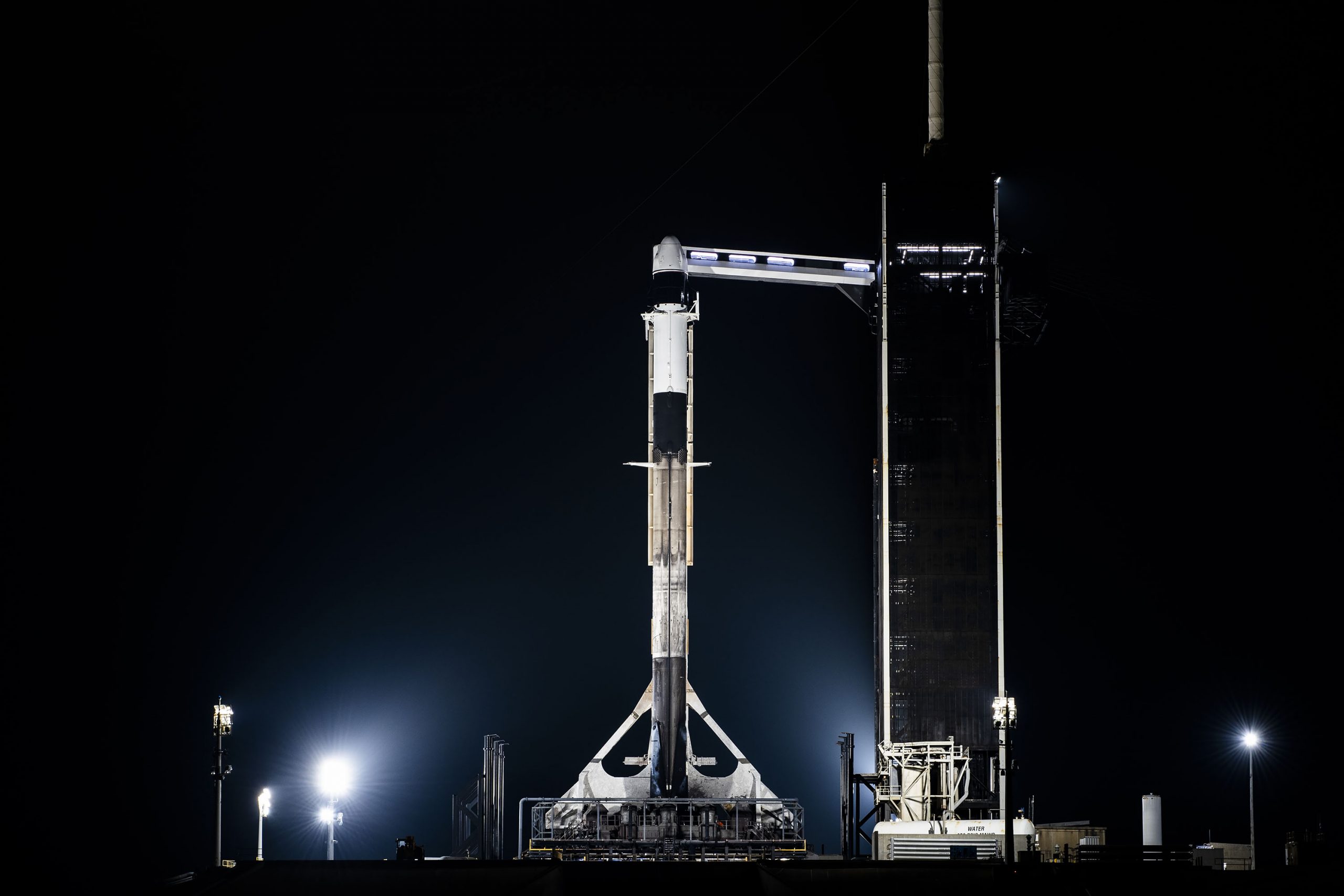 A SpaceX Falcon 9 rocket, with the company’s Dragon spacecraft atop, is raised to a vertical position at NASA Kennedy Space Center’s Launch Complex 39A ahead of SpaceX's 27th resupply services mission to the International Space Station.