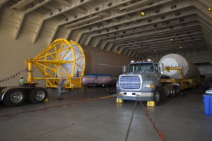 At Port Canaveral in Florida, a United Launch Alliance Atlas V first stage booster and Centaur upper stage are about to be transported from the company's Mariner ship to Cape Canaveral Air Force Station.