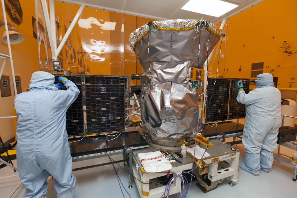 Solar panels are deployed on NASA's TESS satellite in the Payload Hazardous Servicing Facility at Kennedy Space Center.