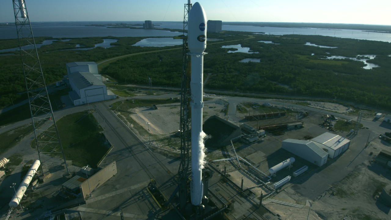 The SpaceX Falcon 9 rocket set to launch NASA's TESS spacecraft stands at Space Launch Complex 40 on Cape Canaveral Air Force Station. The SpaceX Falcon 9 rocket set to launch NASA’s TESS spacecraft stands at Space Launch Complex 40 on Cape Canaveral Air Force Station.