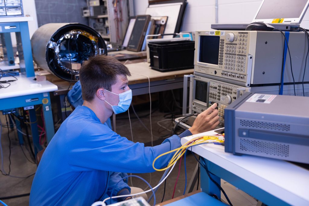 man working on a machine in a lab