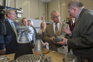 NASA Administrator Charles Bolden looks at models of J-2X and RS-25 rocket engines while talking with Frank Ledbetter, chief of the nonmetallic materials and manufacturing division at NASA's Marshall Space Flight Center in Huntsville, Ala., during a Feb. 22, 2013, visit to the National Center for Advanced Manufacturing Rapid Prototyping Facility. Also participating in the tour are, from left, John Vickers, manager of the National Center for Advanced Manufacturing; Marshall senior applications engineer Rob Black; reporter Lee Roop of the Huntsville Times; Sheri Kittredge, deputy manager of the SLS Liquid Engines Office; and Marshall Center Director Patrick Scheuermann. Image Credit: NASA/Emmett Given  