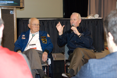 Bruce McCandless and Brian Duffy talking to students and volunteers.