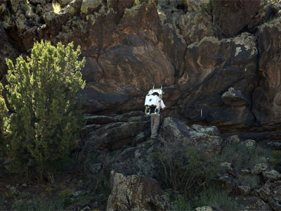 Desert RATS crew member and rock formation