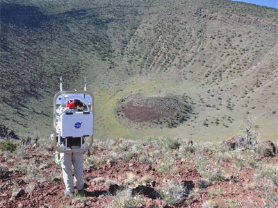 Astronaut Stan Love looking at crater