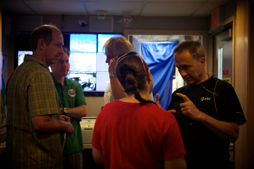 The topside crew discusses scenarios in mission control