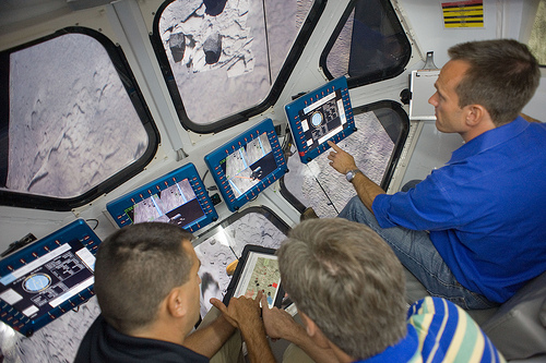 RATS crew members see a visualization of asteroid Itokawa from the windows of the Multi-Mission Space Exploration Vehicle (MMSEV). Photo credit: NASA