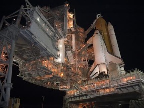 Space shuttle Discovery on the pad at night awaiting launch