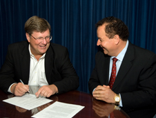 Goddard Center Director Rob Strain (left) and SEEC President Kam Ghaffarian sign the Space Act Agreement. Credit: NASA/Bill Hrybyk