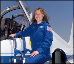 Astronaut Dottie Metcalf-Lindenburger poses beside a T-38 jet trainer